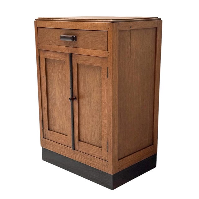 Stunning and elegant Art Deco Modernist cabinet with drawer. Striking Dutch design from the 1920s. Solid oak base with...