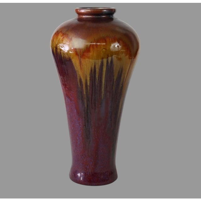 Striking large antique American art pottery vase featuring an unusual flowing flambé-style glaze and impressive 19-inch...