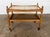 A solid oak two-tier bar trolley by Henning Kjærnulf, Denmark, 1960s. The upper tier is inset with twelve hand-painted...