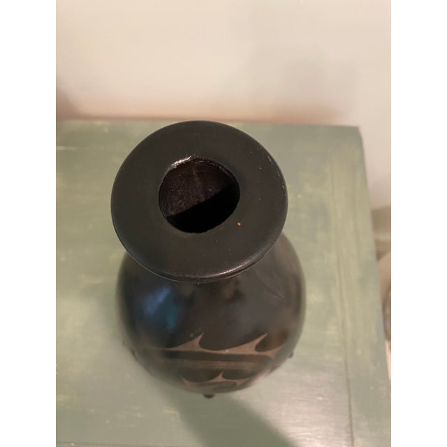 Mata Ortiz style beautiful hand-turned geometric blackware vase, black on black. The pottery piece is made of black glaze...