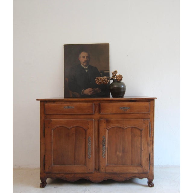 A French provincial sideboard or buffet from the late 18th century. Solidly crafted in walnut. Ready for everyday use with...