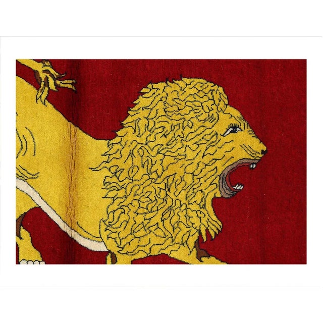 A modern Persian Shiraz small throw rug handmade during the 21st century with a pictorial design of a male lion in a red...