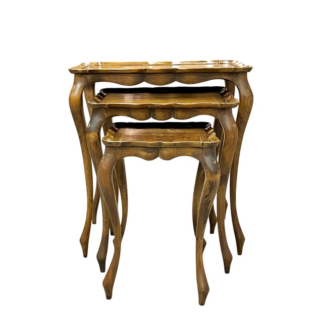 Set of 3 Franco Tacchi wood nesting tables with gilt detailing. The tables have a charming pie crust edge and small gilt...