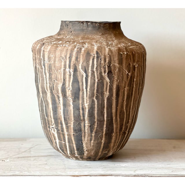 VESSEL - CAUDAL stoneware with glaze A large jar form in handbuilt black clay. The glaze was watered down and allowed to...