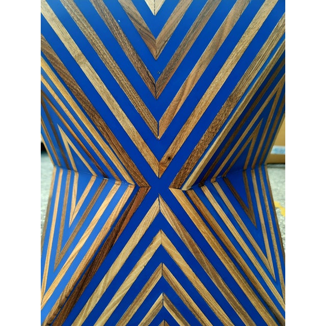 A striking handmade Moroccan stool crafted from solid wood and resin, featuring an intricate geometric design that feels...