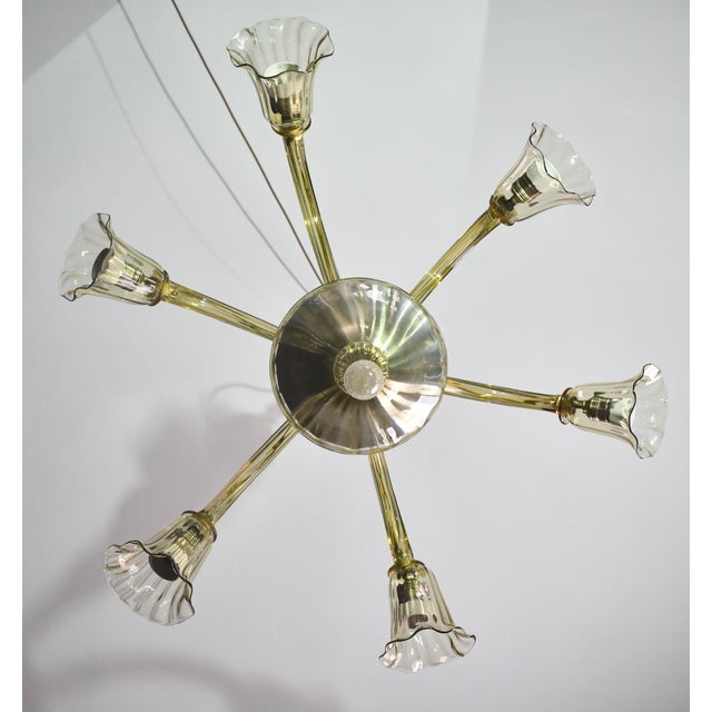 Fantastic amber-colored Murano glass chandelier. Design period: 1950-1960. The chandelier consists of 6 arms with 6 light...