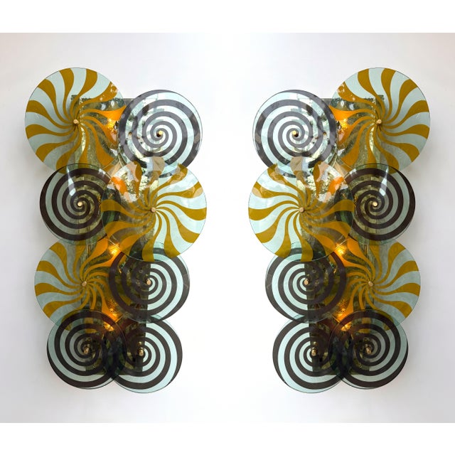 Pair of wall lights lamps sconces in brass and spiral discs Murano glass, Contemporary work from a small italian design...