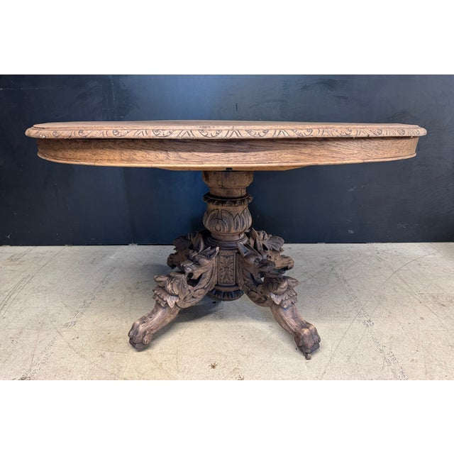 A good French Oak Hunting Table, dating to the mid 19th Century. Heavily carved base featuring griffins. We have bleached...