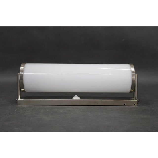 Original bauhaus tubular wall light, made in czechoslovakia in the 1930s, featuring a creamy glass tube with chrome-plated...