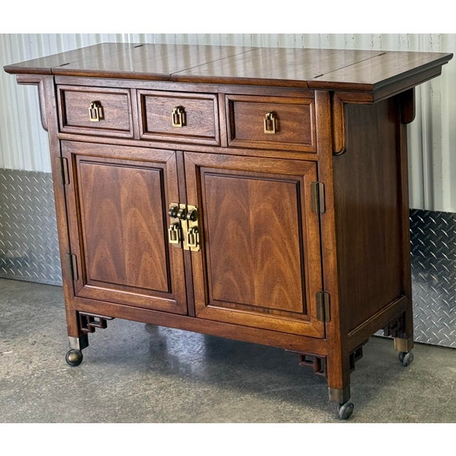 Beautiful server / cart by Century furniture. Features three dovetailed drawers, storage compartment, faux stone flip top...