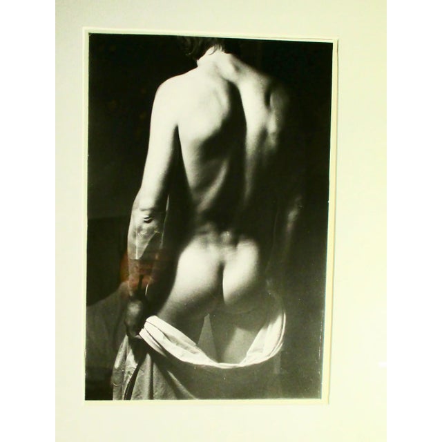 Black and white photograph of a male nude. Fine art photography of the classic take on male form. Dramatic darks and the...