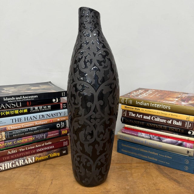 "About This Piece About This Piece This vase is a study in elegance and mystery, where timeless design meets bold...