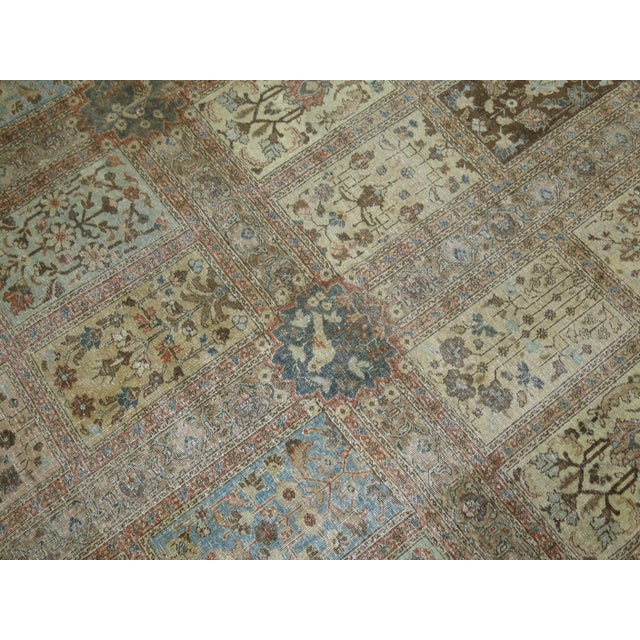 A room size antique Persian Tabriz Oriental rug woven early 20th century with a garden box all over design in earth tones...