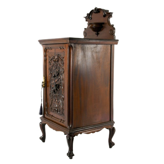 Handcrafted by the esteemed English furniture maker James Allen & Sons, this beautifully carved Victorian bedside cabinet...