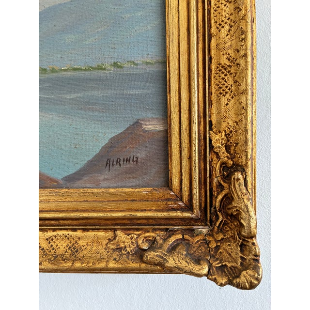 This original vintage landscape oil painting, from around 1920, shows a castle beside a mountain lake, with snow-covered...