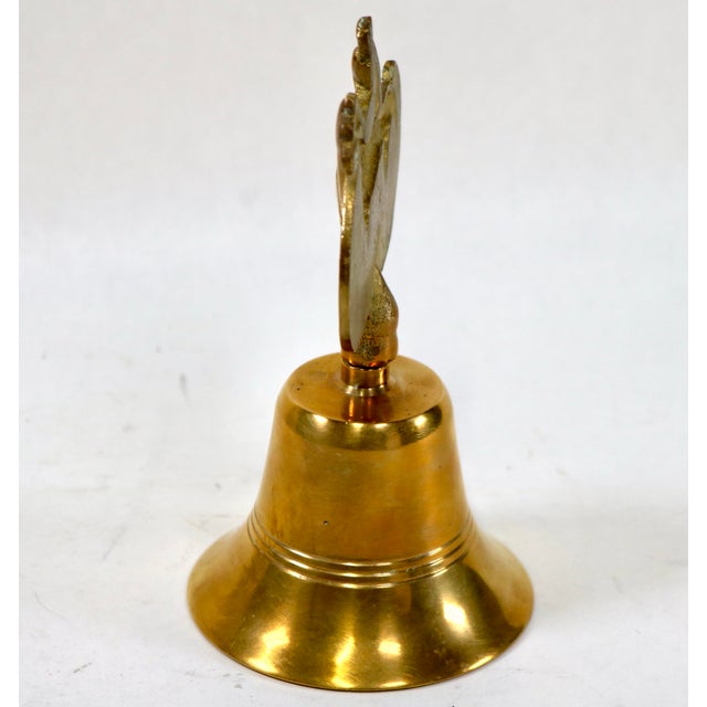 Add a touch of classic English country charm to your bar cart, desk, or bookshelf with this vintage solid brass hand bell....