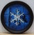 This circular oil painting features a meticulously rendered paper snowflake, its intricate design starkly contrasted...