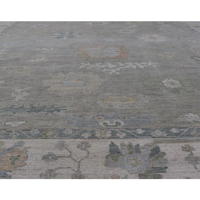 Measures: 11'11 x 14'8 All-over floral modern Oushak with light tan background and cream border. Keivan Woven Arts rug...