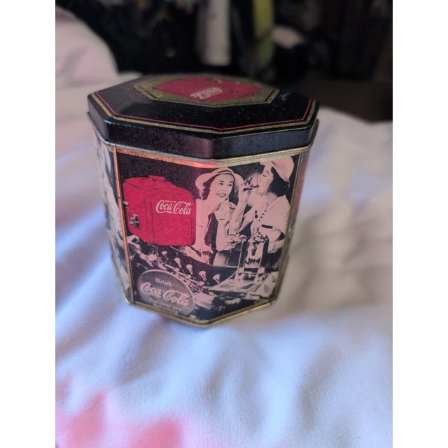 Vintage decorative tin by Coca-Cola featuring a retro design. • Octagonal shape with nostalgic imagery • Classic Coca-Cola...