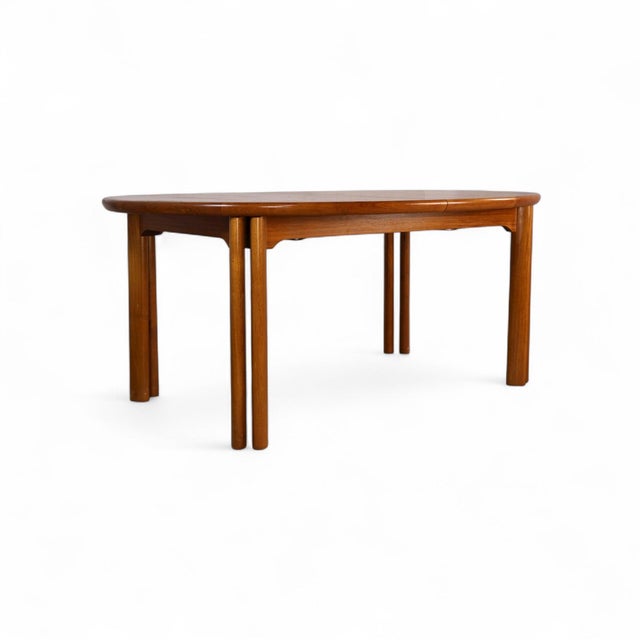 This vintage Danish Modern teak dining table by Skovby offers exceptional form and function in one streamlined silhouette....