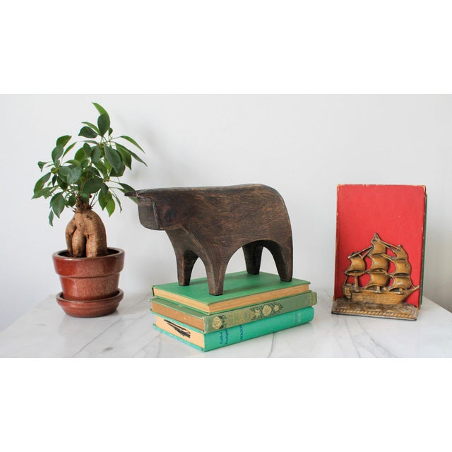 Hand carved Crate and Barrel Brown Wood Bull Sculpture. Some age wear to wood. Pictured. Made in India. No makers mark.