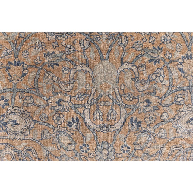 An early 20th century Persian rug patterns, the honey field a subtle allover trellis of swirling flowering vinery,...