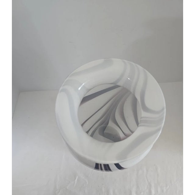 A stunning Mid-Century Modern art glass vase in the style of Carlo Moretti, featuring an elegant swirl of purple and white...