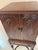 A tall mid‑century mahogany flatware cabinet on stand, featuring seven velvet‑lined drawers designed to hold a complete...