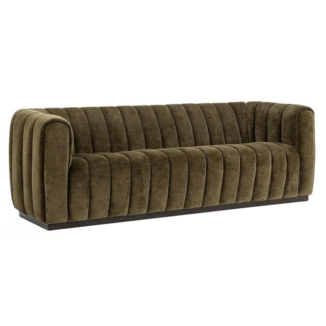 Beautiful olive green toned velvet sofa with classic channel tufting. Midcentury modern style with warm rich color.