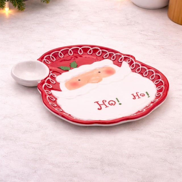 Serve up holiday cheer with this Santa Ho Ho Ho Ceramic Plate Set. Featuring a jolly Santa face framed by a festive red...