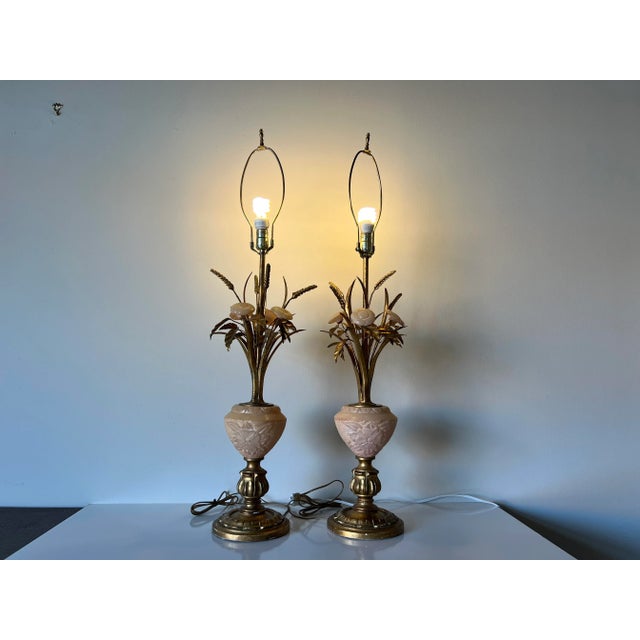 A wonderful tall Italian Hollywood Regency table lamps a pair, features long gilt metal wheatsheaves, carved marble with...