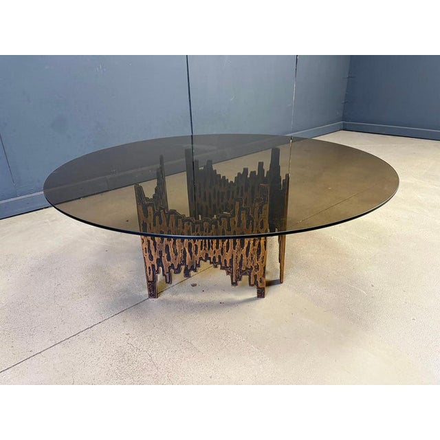 A bronze base 'Paul Evans' Style coffee table with a round smoked glass top. Beautiful and as far as we've seen, unique...
