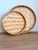 A charming pair of traditionally styled handwoven bamboo trays featuring intricate herringbone weaving, warm natural...