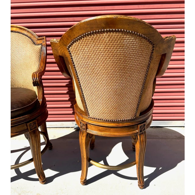 Vintage Pair of Century Furniture Counter Swivel Stools with leather seats and upholstered back. Carved detail throughout...