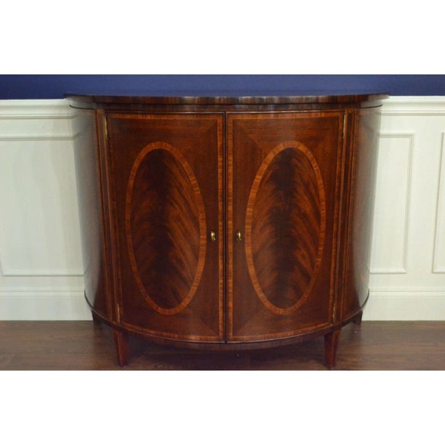 This is a mahogany Demilune cabinet made by Leighton Hall. It is ideal for foyers, hallways, bedrooms or living areas for...