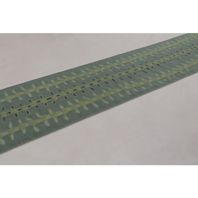 Handwoven in wool and undyed natural yarns, this 3x12 runner and flatweave is a premier selection from our contemporary...