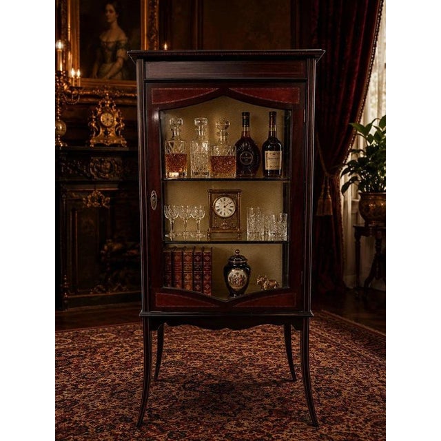 A beautiful antique Edwardian mahogany display cabinet, dating to the early 20th century and distinguished by elegant...