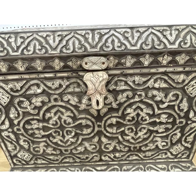 Exquisite antique wooden chest richly adorned with detailed wood inlay featuring elaborate arabesque, foliate, and...