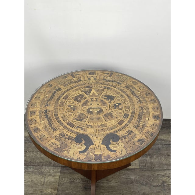 Aztec coffee table made of rosewood. A stylish coffee table with a round top in an Aztec pattern. Crafted from rosewood,...