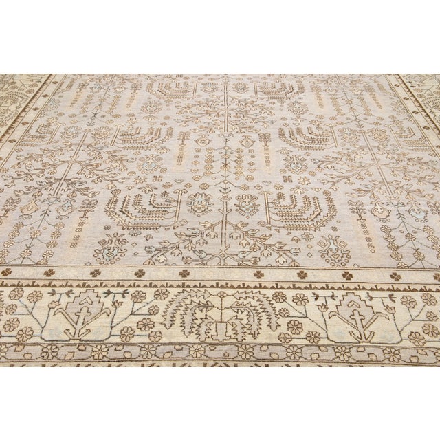 Beautiful contemporary Oushak hand-knotted wool rug with a beige field. This Oushak rug has a scattered brown and blue...