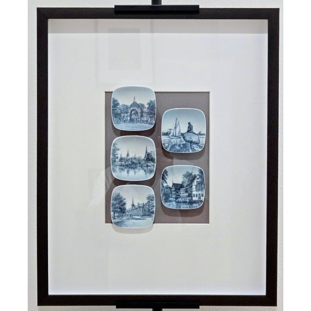 Framed set of five vintage Bing & Grondahl (B&G) blue and white porcelain mini wall plates featuring iconic Danish...