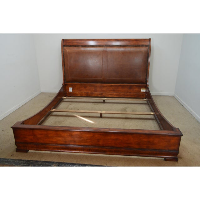 King Bed by Henredon. Store item #573. It features leather nailhead headboard and solid wood construction. Artificially...