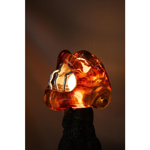 Somehow Honey Dreams Of Fire consists of two handcrafted table lamps. The solid glass lampshades are crafted by French...