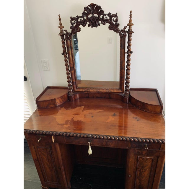 This stunning Burr walnut antique pedestal dressing table does show signs of use but features incredible carved detail and...