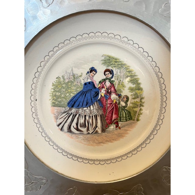 This item is a vintage Farberware serving platter featuring a porcelain plate insert with a Victorian scene framed by...