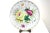 Intricately hand-painted floral porcelain plate with rose flowers in ruby red, deep green, vibrant yellow, and gold gilt....