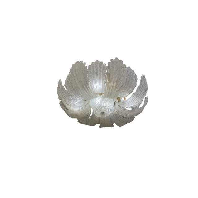 This ceiling light is crafted from Murano glass with petals handmade by Venetian glassblowers. Arranged alternately on a...