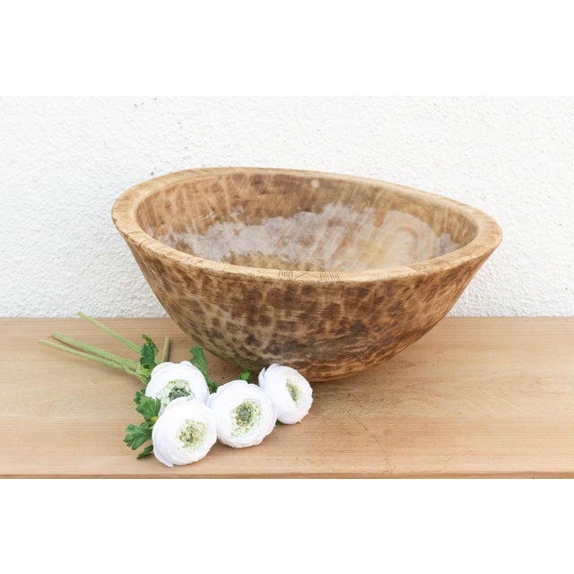 There is something deeply grounding about holding a vessel that was hewn by hand from a single block of wood. This antique...