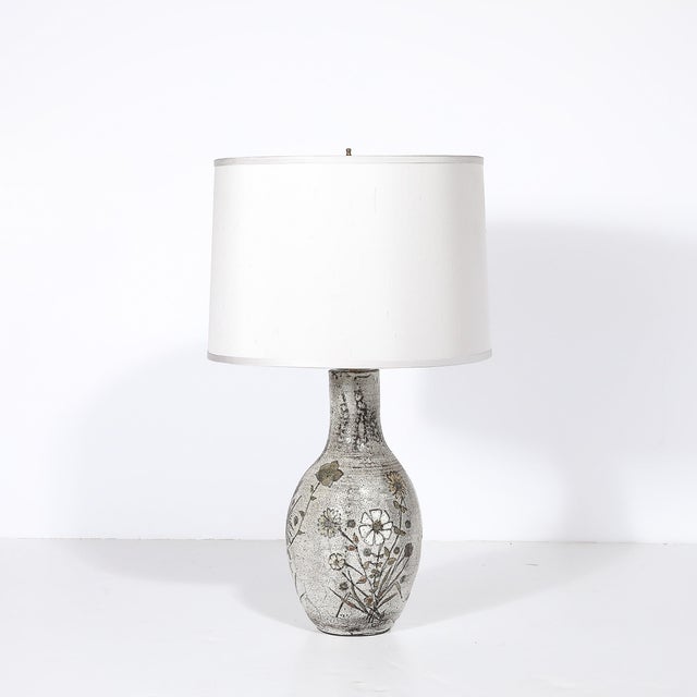 This elegant Mid-Century Modern ceramic table lamp, crafted in France circa 1950, seamlessly blends functionality with...