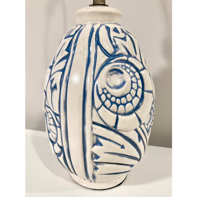 This vintage ceramic lamp features a distinctive incised, hand-painted blue pattern which straddles the line between...
